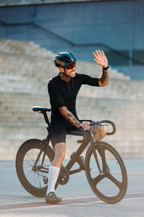 Tattooed Cyclist Greets Morning Sunlight In Urban Ride
