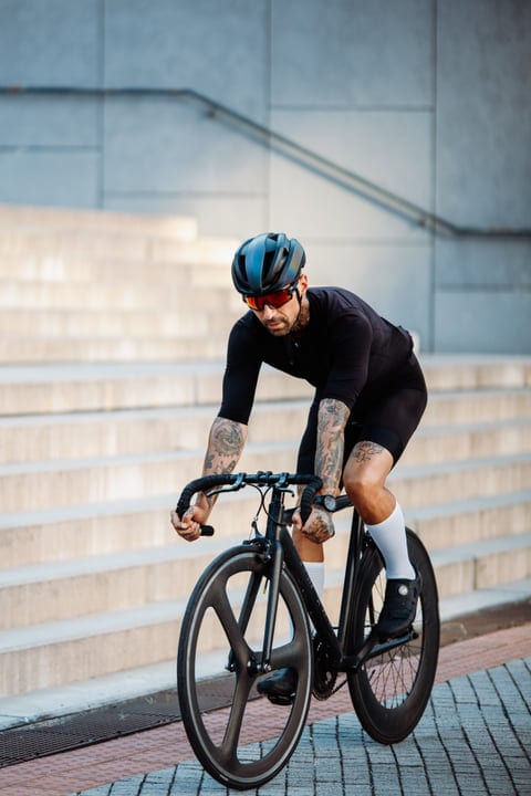 Cyclist Powers Through Urban Streets In Style