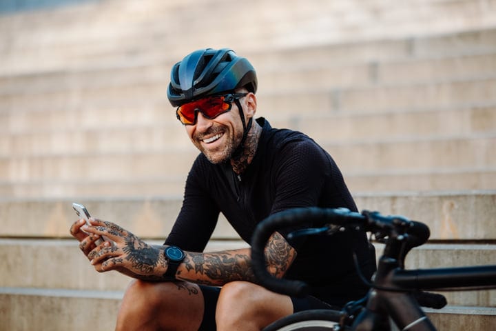 Tattooed Cyclist Takes A Break With A Smile