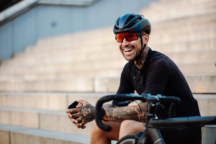 Tattooed Cyclist Takes A Break With A Smile