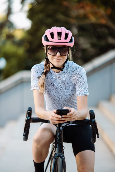 Cyclist Pauses for a Moment in Vibrant Cityscape