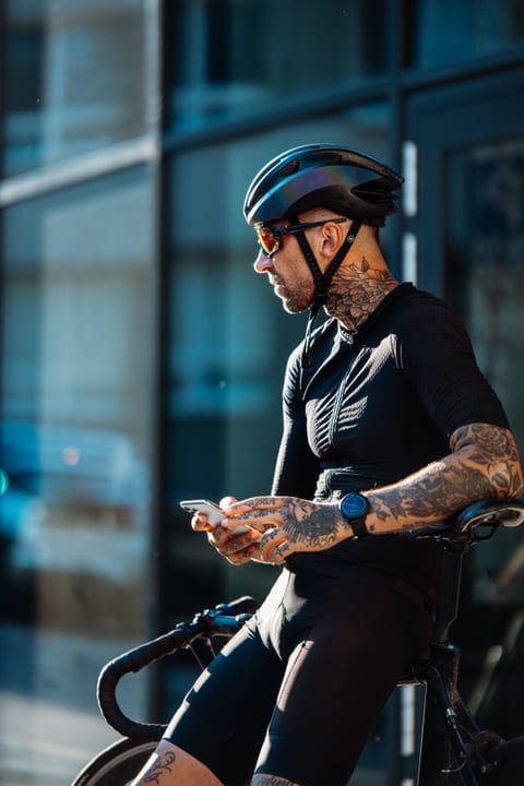 Urban Cyclist Taking A Break In The Sunlit City