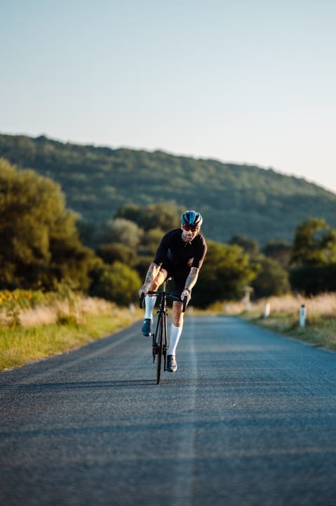 Cyclist Embraces Open Road On A Sunny Day