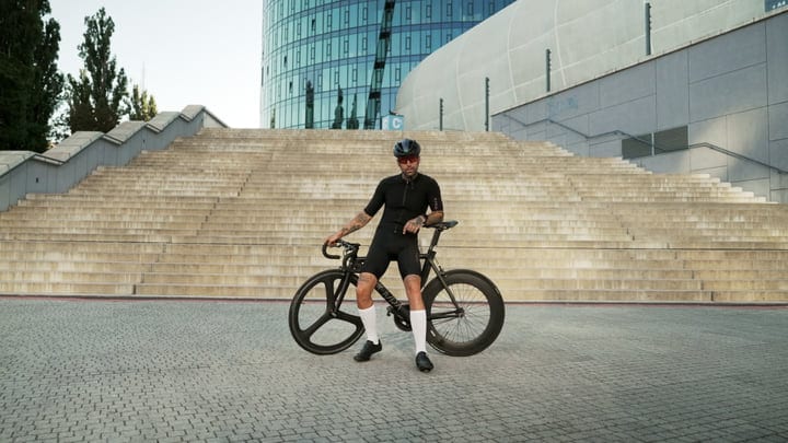 Urban Cyclist Pauses By Modern Architecture Steps
