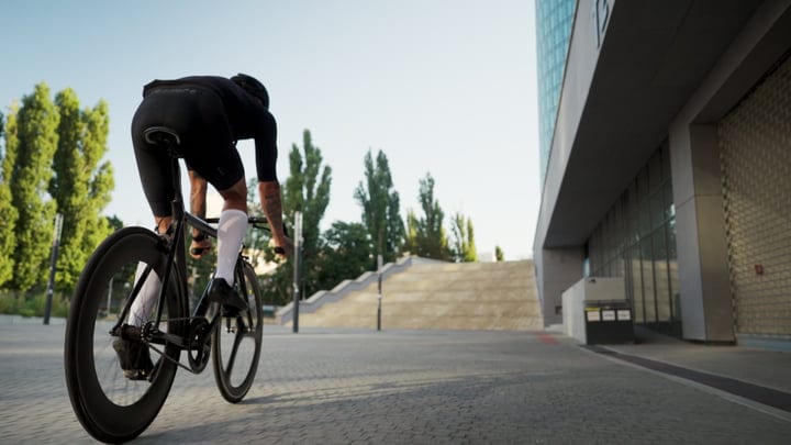 Morning Cyclist Glides Through Modern Cityscape