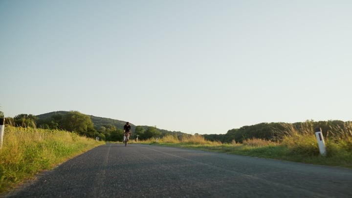 Cyclist Gliding Through Serene Countryside Morning Ride