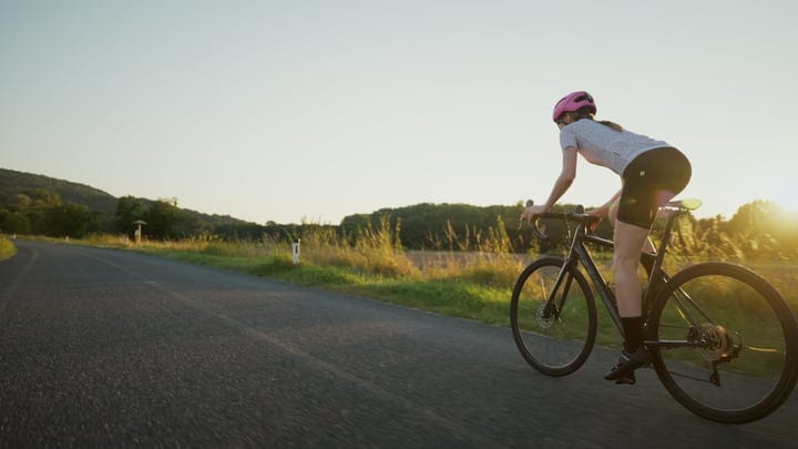Cyclist Embraces The Open Road At Golden Hour
