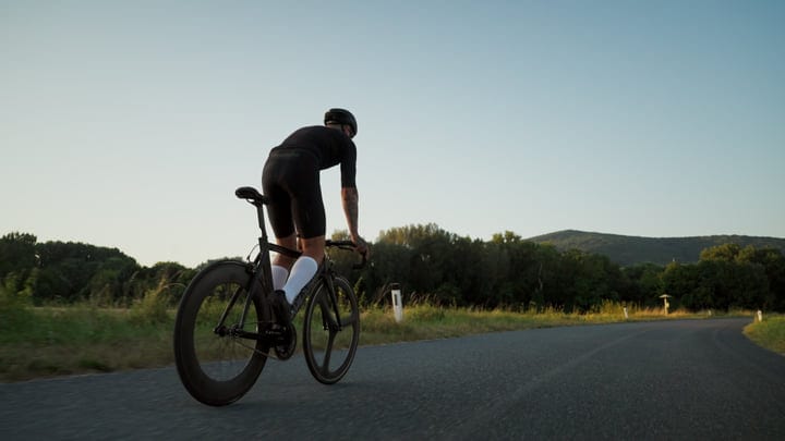 Cyclist Embraces Open Road On A Sunny Morning