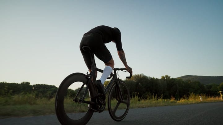 Cyclist Powers Through Sunrise On Countryside Road