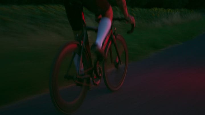 Blurring Wheels Against the Urban Evening Glow