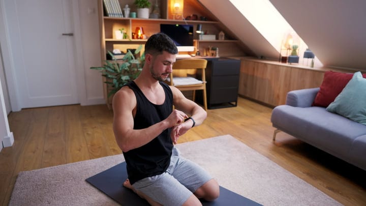 Focused Man Balancing Fitness and Work in Cozy Home
