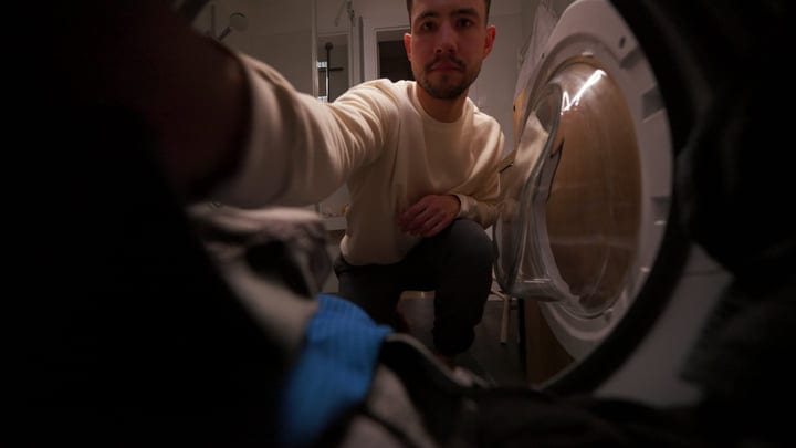 A Man Balances Laundry With Remote Work Duties