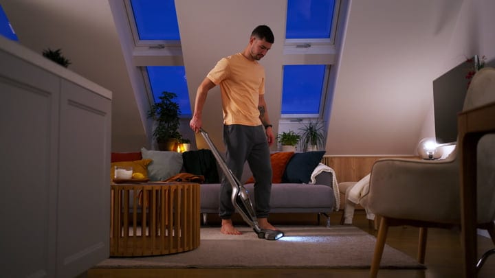 Man Balancing Home Chores and Work in Evening Light