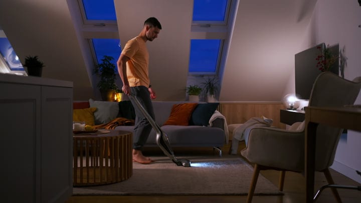 Man Tending To Evening Chores In Cozy Loft