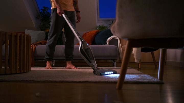 Evening Routine: Man Vacuuming His Cozy Living Space