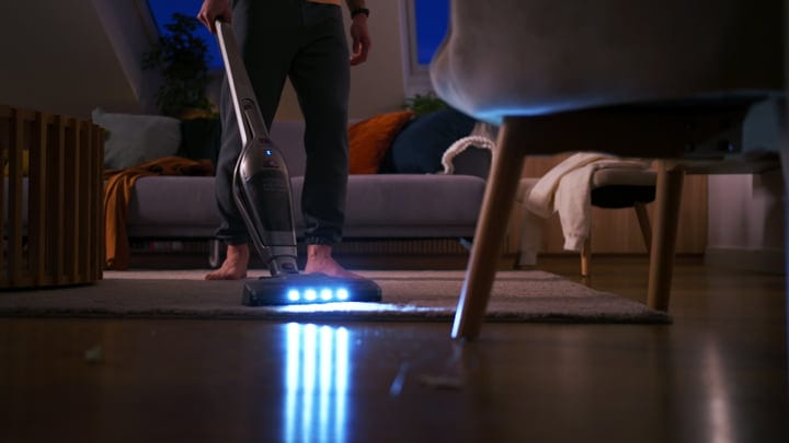 Evening Routine: A Man Vacuuming His Cozy Living Room