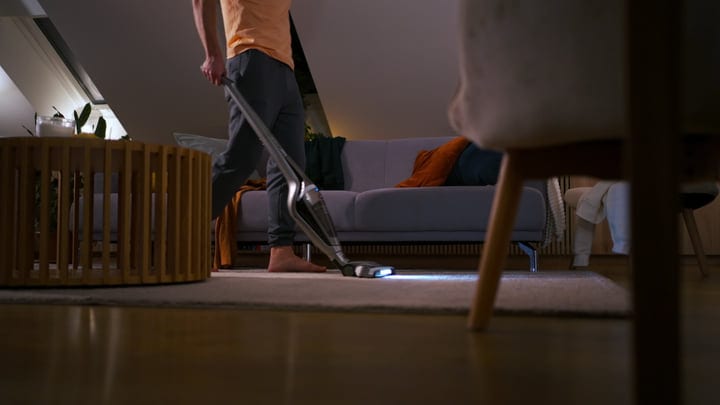 Man Navigates Cozy Home With a Cordless Vacuum