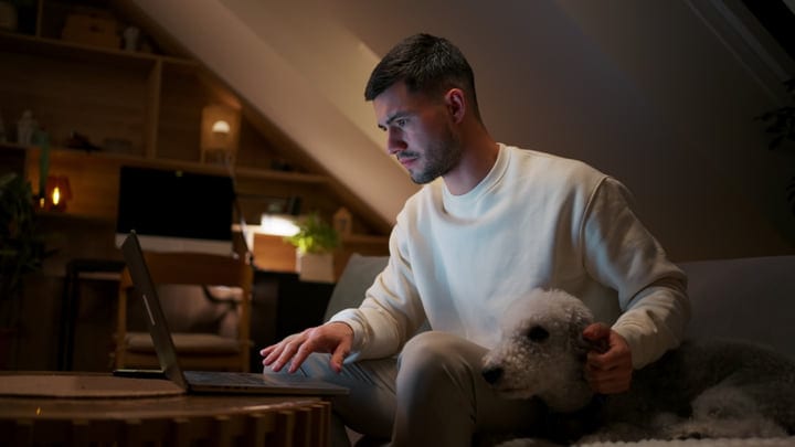 Evening Focus: Man Balances Work And Comfort At Home