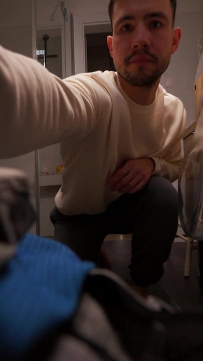 Man Adjusts Camera For A Cozy Home Office Setup