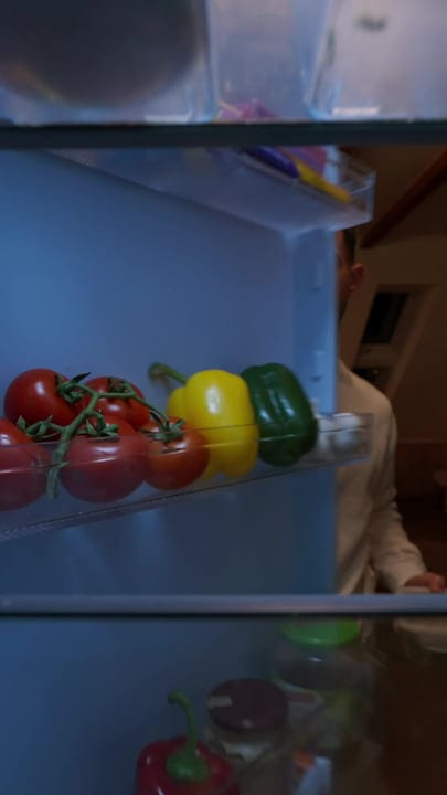 Man Reaches Into Refrigerator For Fresh Vegetables