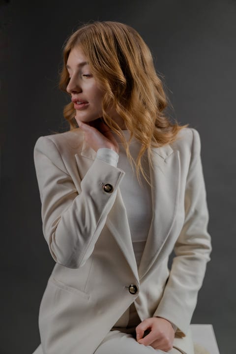 Elegant Woman Posing Thoughtfully In Studio Light