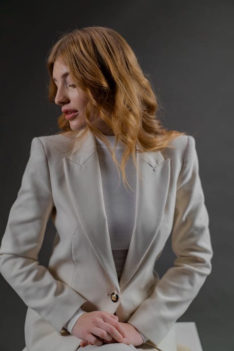 Elegance Captured: Woman In White Blazer Posing Gracefully