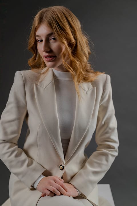 Elegant Studio Portrait Of A Woman In Cream Suit