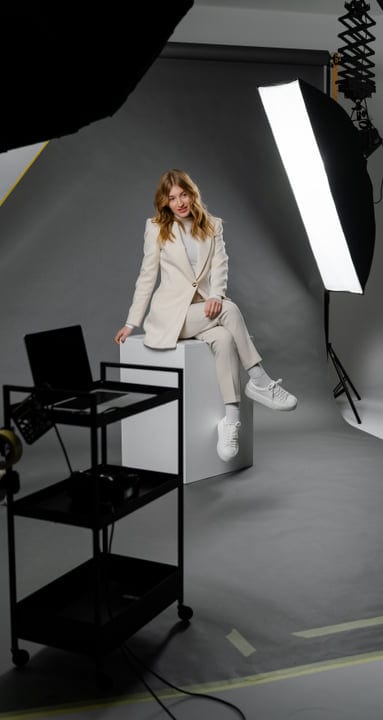 Confident Professional Posing in Modern Studio Environment