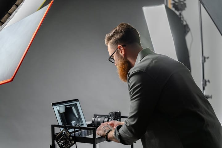 A Photographer Reviews Shots in a Modern Studio