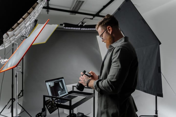 Creative Photographer Adjusts Camera In Modern Studio Setup