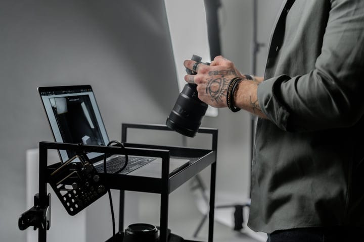 Creative Hands Prepare Camera Gear In Studio Light