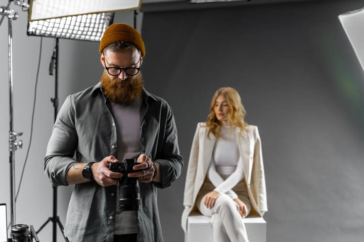 Focused Photographer Captures Elegant Model In Studio Setting
