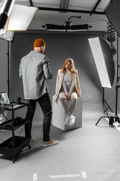 Photographer Directs Model in Modern Studio Setting