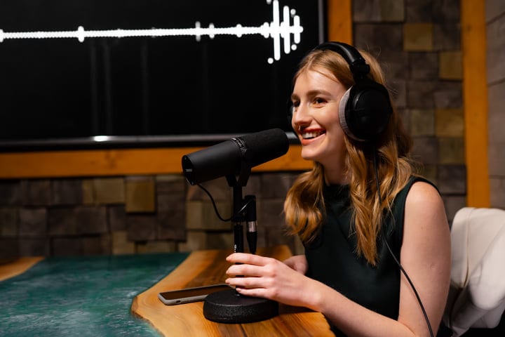 Engaging Podcast Host in Modern Recording Studio