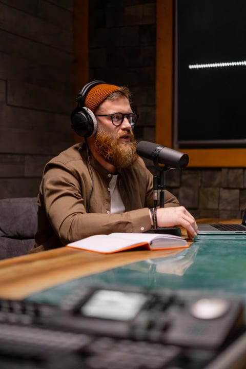 Bearded Podcaster Engages With Audience In Cozy Studio