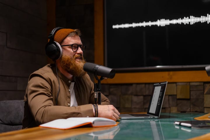 Bearded Podcaster Engaged In Creative Studio Environment