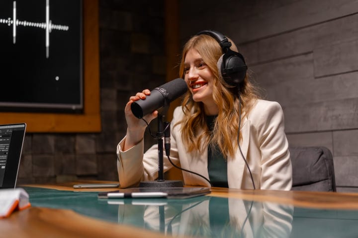 Engaging Podcast Host Speaks Into Microphone In Studio
