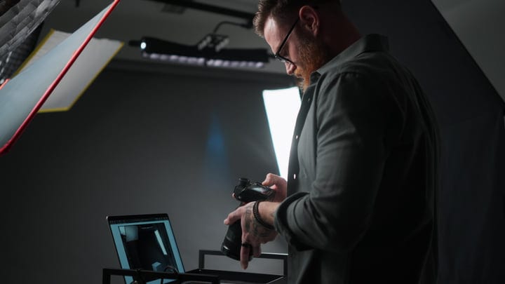 Photographer Reviews Shots Under Studio Lights