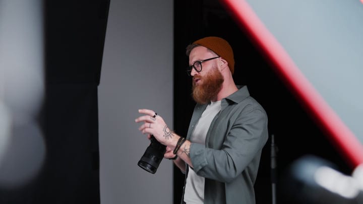 Creative Photographer Engaged In Dynamic Studio Setup