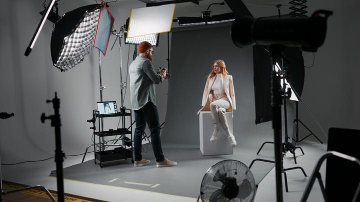 Photographer Directs Model in Modern Studio Environment
