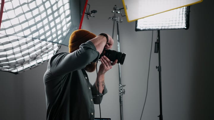 Photographer Focuses Amid Professional Studio Lighting Setup