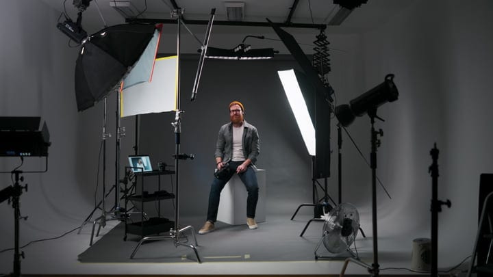 Photographer Poised in Modern Studio Lighting Setup