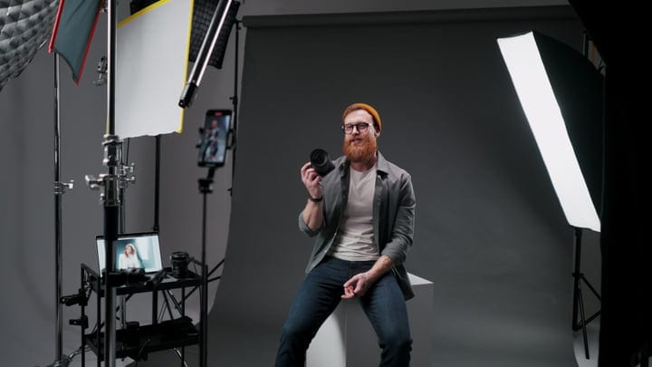Photographer Holding Camera Lens In Modern Studio Setup