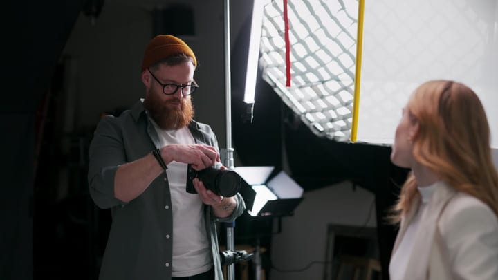 Photographer Adjusts Camera In Modern Studio Setup