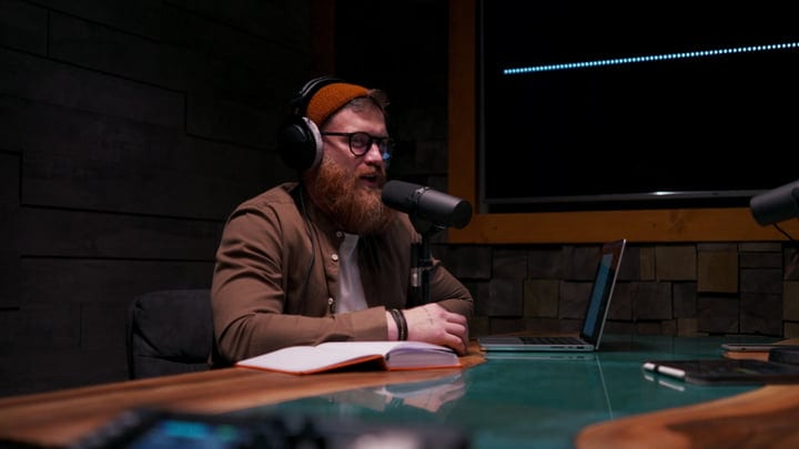 Podcast Host Engaging Audience From Cozy Studio