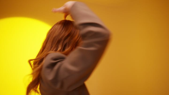 Vibrant Movement Against A Bold Yellow Backdrop