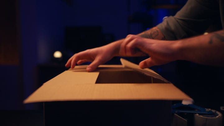 Hands Carefully Unbox Equipment In Studio Ambiance
