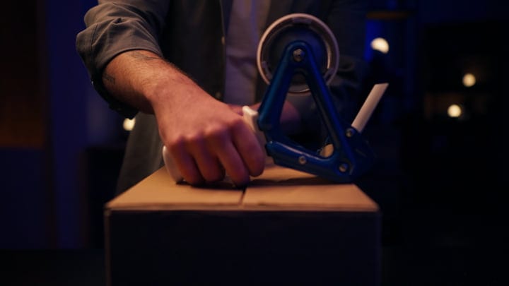Precision Unfolds Under Studio Lights With Tape Dispenser