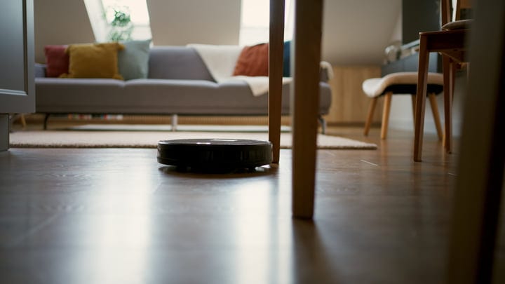 Modern Serenity: A Robot Vacuum Glides Through Cozy Living Room