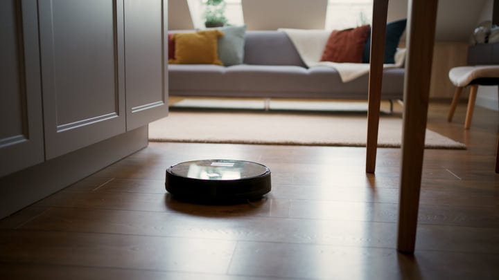 A Robot Vacuum Navigates A Cozy Living Room Scene